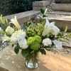 An airy arrangement of white and green flowers with a hint of