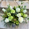A beautiful cream and green mix bouquet in a gray ceramic container