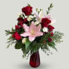 This elegant arrangement includes fragrant pink lilies, red roses, alstroemeria, mini-carnations, and
