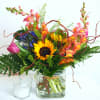 Colorful. Uplifting. Whimsical. 

This cheerful, garden-style display features sunflowers, snapdragons or stock