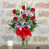 6 STEMS OF ANY CLOLOR ROSES DESIGNS IN A CLEAR VASE THE