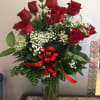 12 Red roses arranged in glass vase w/ Babies Breath, greens &amp;