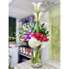 Cylinder clear 6x10 vase accented with stones decorated with hydrangeas, calla lilies