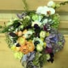 Stylish medley in purple, peach, white and green hues, presented in a