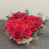 Red roses and red carnations arranged in a heart shaped box. 