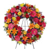 Standing wreath arrangement with red roses and carnations; orange Asiatic lilies and