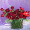 Variety of red premium blooms in a clear glass 12&quot; oval vase.
