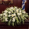 A beautiful collection of white flowers and elegant greens beautifully arranged to