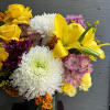 Bright and cheerful arrangement with roses and lilies. 