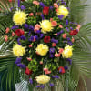 A wonderful combination of yellow, red and purple flowers arranged for a