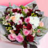 A mixture of 12 red and 12 pink roses and other seasonal
