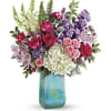 What a beauty! Shimmering with a glorious iridescent finish, this breathtaking, hand-blown
