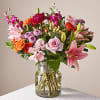 This vibrant bouquet features roses, lilies, carnations &amp; more flowers to show