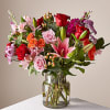 This vibrant bouquet features roses, lilies, carnations &amp; more flowers to show