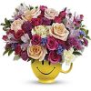 Send a cuppa cheer with this happy surprise of colorful roses and