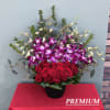 This charming arrangement combines the classic beauty of red roses with the