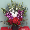 This charming arrangement combines the classic beauty of red roses with the