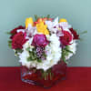 Joyful arrangement of Roses, Orchids, Hydrangeas, and Greens designed in a vase