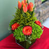 A low vase holding Roses, Hydrangeas and Tulips. 7&quot; wide, 12&quot; high.