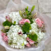 A all around loose bouquet arrangement of vibrant flowers and bright white