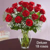 Send a gorgeous arrangement of premium red Freedom roses with vase, greens