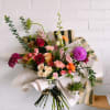 This wrap bouquet is uniquely crafted with fresh colorful florals that you