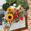 This arrangement is uniquely crafted with bright and fresh florals. Arrangement and