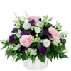  White basket of fresh flowers in pink, white and purple, expertly