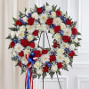 The standing wreath arrangement is meticulously crafted to honor a special someone