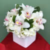 Orchids and Hydrangeas blended in a white vase to fit any decor