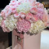 This exquisite floral arrangement captures elegance and grace with its soft, pastel