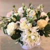 Peonies, roses, lisianthus and tweedia all white with a touch of blue.
