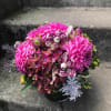 A compact arrangement perfectly scaled for a small desk, nightstand or side