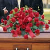 This classic casket spray featuring red carnations expresses your everlasting love and