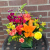 In a cube vase and full of bold and vibrant yellows, hot