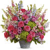 This arrangement features green hydrangea, hot pink roses, lavender spray roses, light