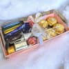 A pink box of mix chocolate of Ferrero Rocher, Lindt, Hershey&#039;s, Godiva