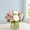 The graceful arrangement in shades of blush pink and creamy white is