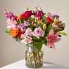 This vibrant bouquet features roses, lilies, carnations &amp; more flowers to show