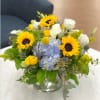 Delightful arrangement of yellow sunflowers accented with blue hydrangea and other assorted