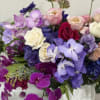 A seasonal array featuring primarily pink, purple, red, and green tones designed