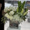 This lovely arrangement in a vase of mostly whites and hints of