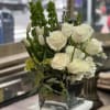 This lovely arrangement in a vase of mostly whites and hints of