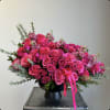 A vase-based arrangement of pink roses showcases the classic elegance and beauty
