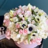 Stylish design in a box with hydrangeas, anemones, spray roses and roses.