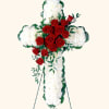 White carnations and red roses are designed into this religious floral display.