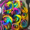 A dozen bright, colorful and fun tie dye roses with greens and