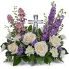 Soft and serene, this artistic array of cream and lavender blooms around