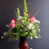 A lush airy arrangement filled with Roses, Lilies, Alstroemeria, Bells of Ireland