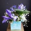 A small sweet arrangement in a robin egg blue vase to help